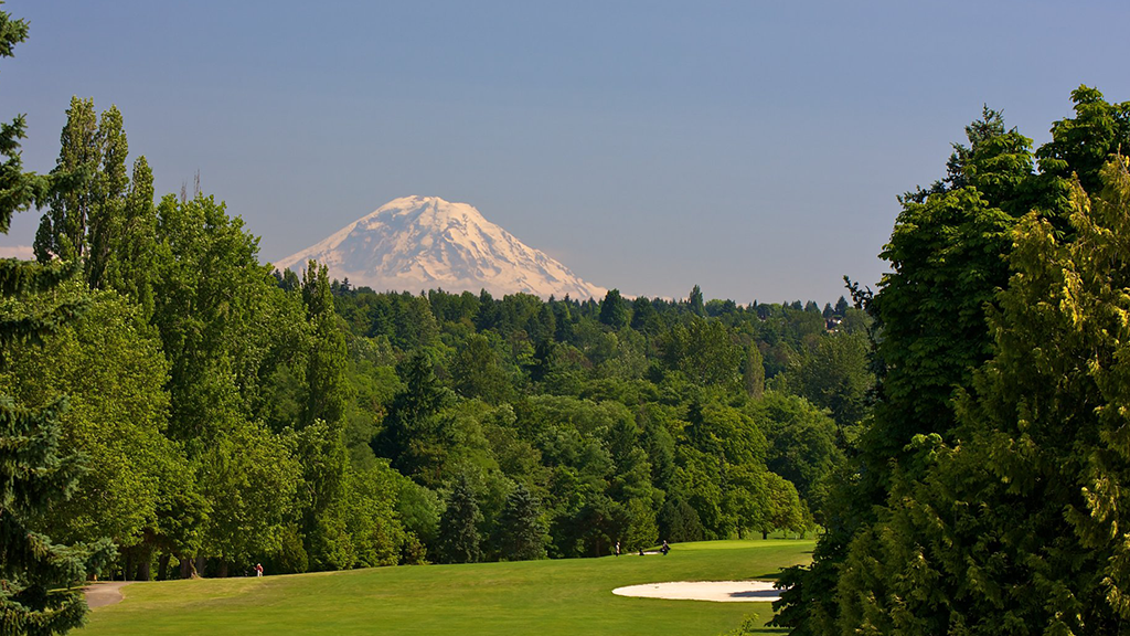 View of golf course with mountain in distance